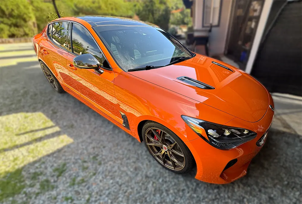 Orange Kia Stinger with a freshly detailed exterior