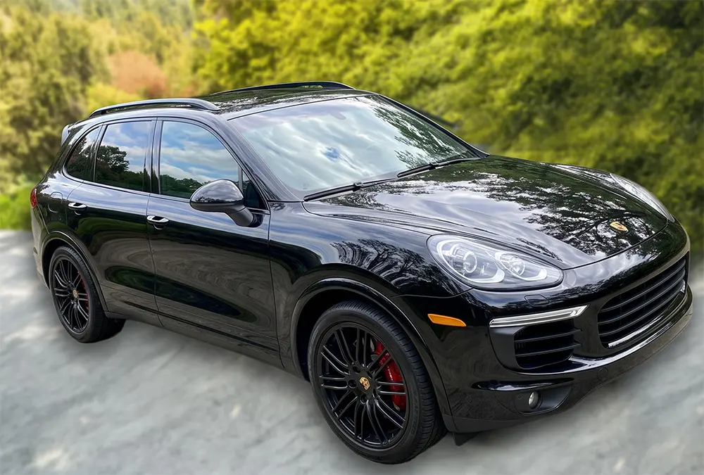Black Porsche SUV with a glossy detailed finish